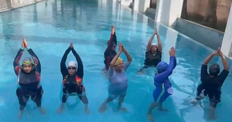 Aqua yoga group in pool
