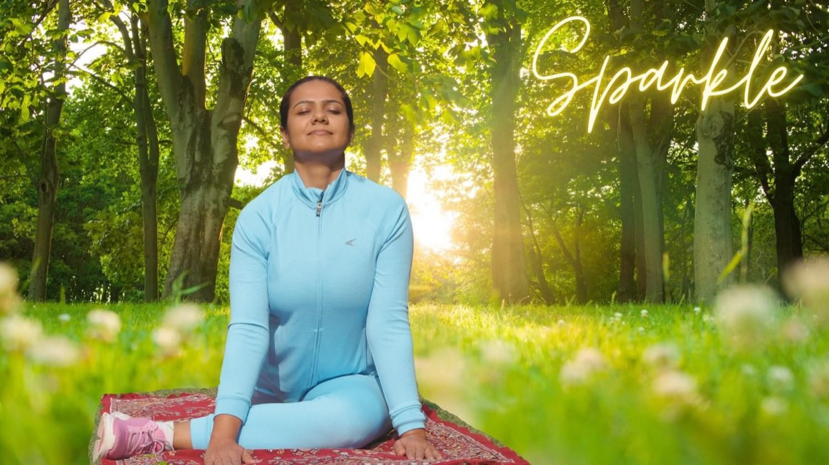 Kanchan meditating in a sunlit forest